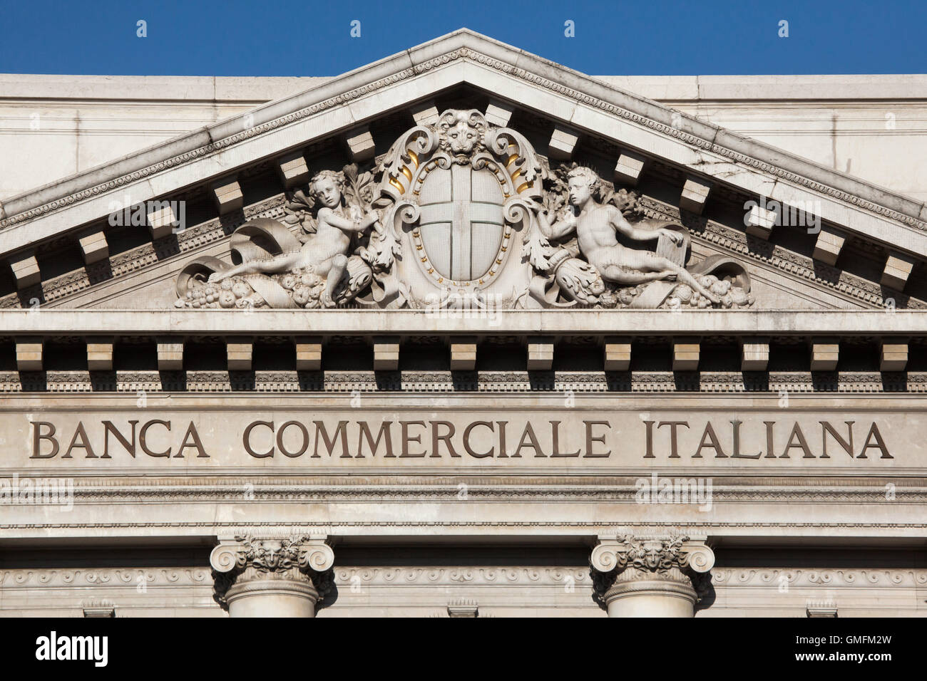 Coat of arms of Milan depicted in the tympanum of the Palace of the Banca Commerciale Italiana in Piazza della Scala in Milan, Lombardy, Italy. The Palace of the Banca Commerciale Italiana designed by Italian architect Luca Beltrami was built in the early 20th century. Stock Photo