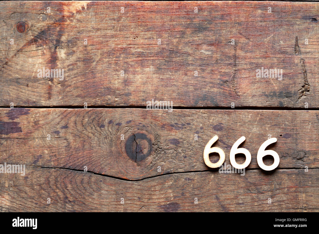 666 sign on old wooden background with free space Stock Photo