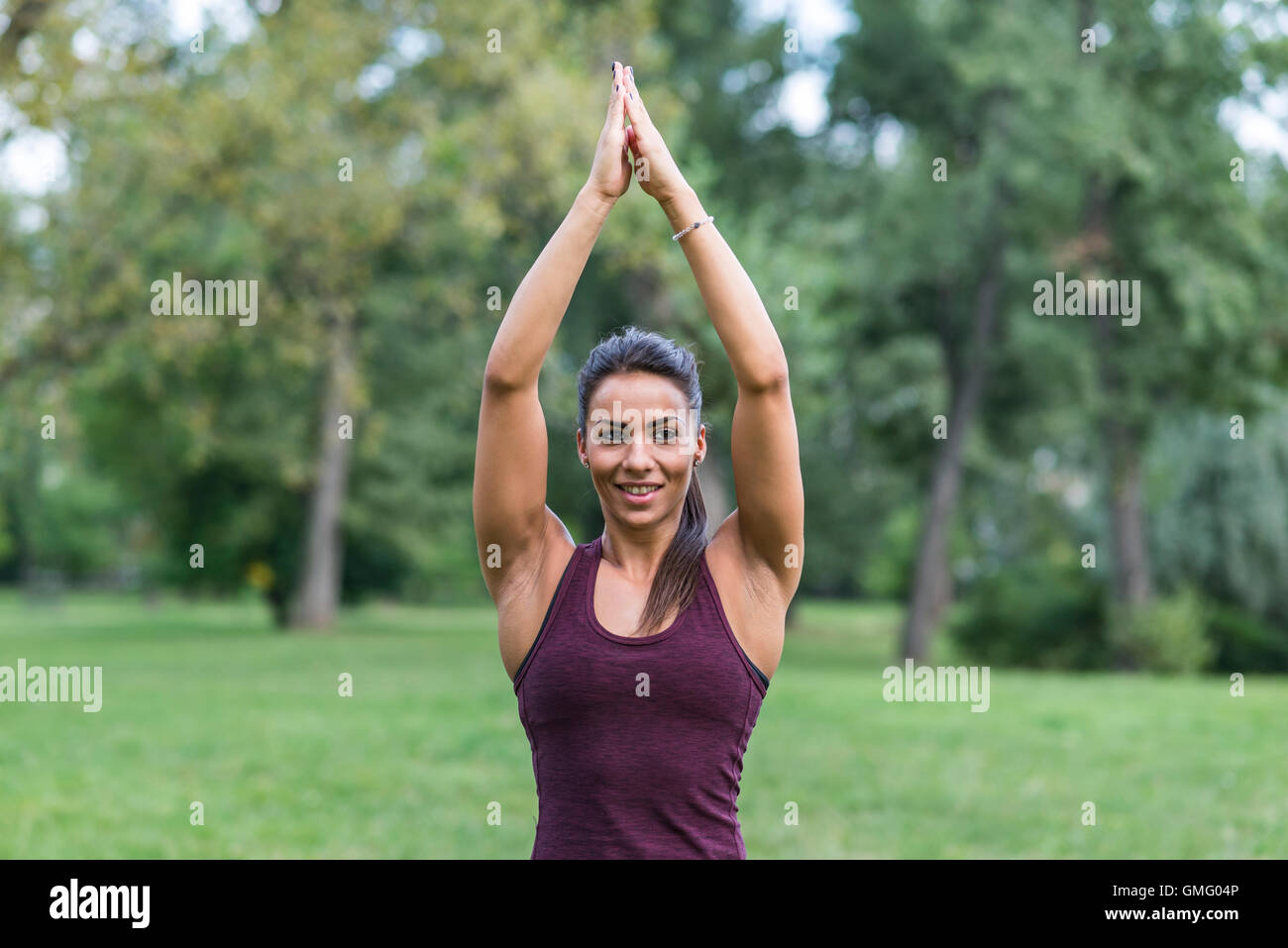 Young woman taking exercises in a park Stock Photo - Alamy