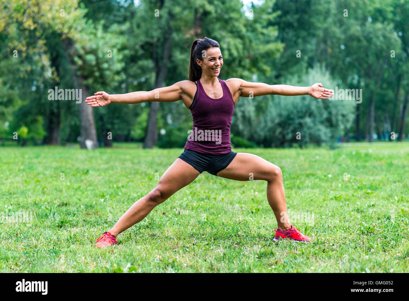 Young woman taking exercises in a park Stock Photo Alamy