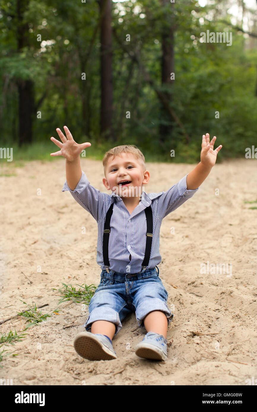 Boy sitting on the sand Stock Photo - Alamy