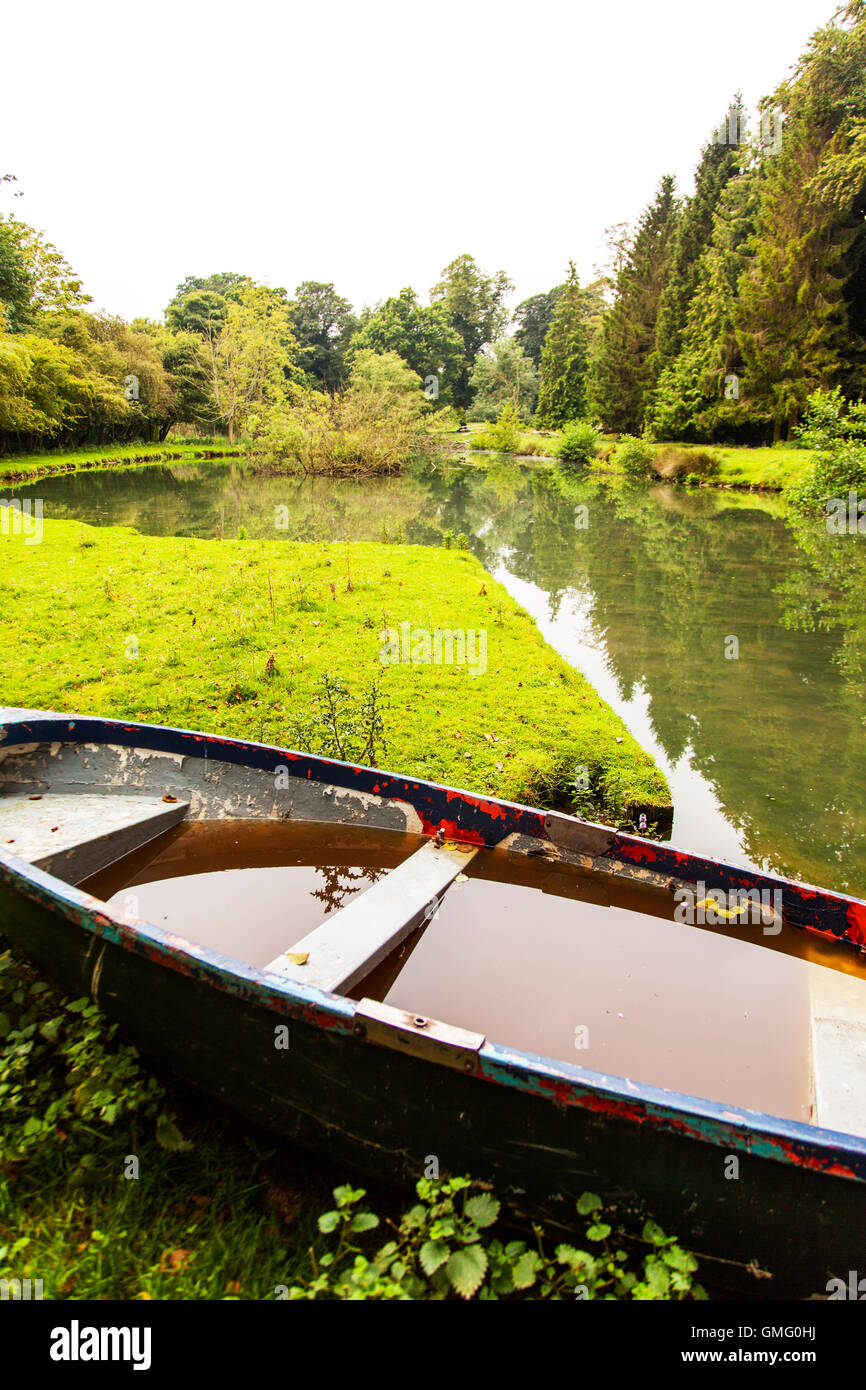 Hole in boat full of water sinking boat taking in water leaking boats Lincolnshire UK England GB Stock Photo