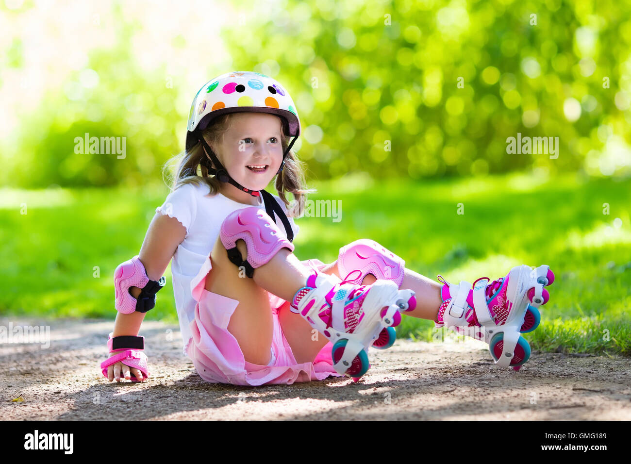 Little Girl Learning To Roller Skate In Sunny Summer Park. Child Wearing  Protection Elbow And Knee Pads, Wrist Guards And Safety Helmet For Safe  Roller Skating Ride. Active Outdoor Sport For Kids.