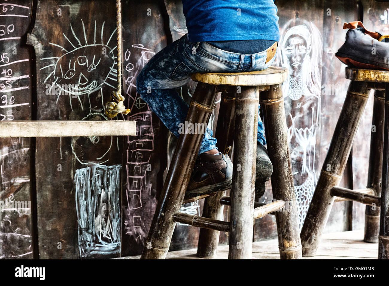 Man sitting at a bar on a barstool, Dominical village, Costa Rica, Central America Stock Photo