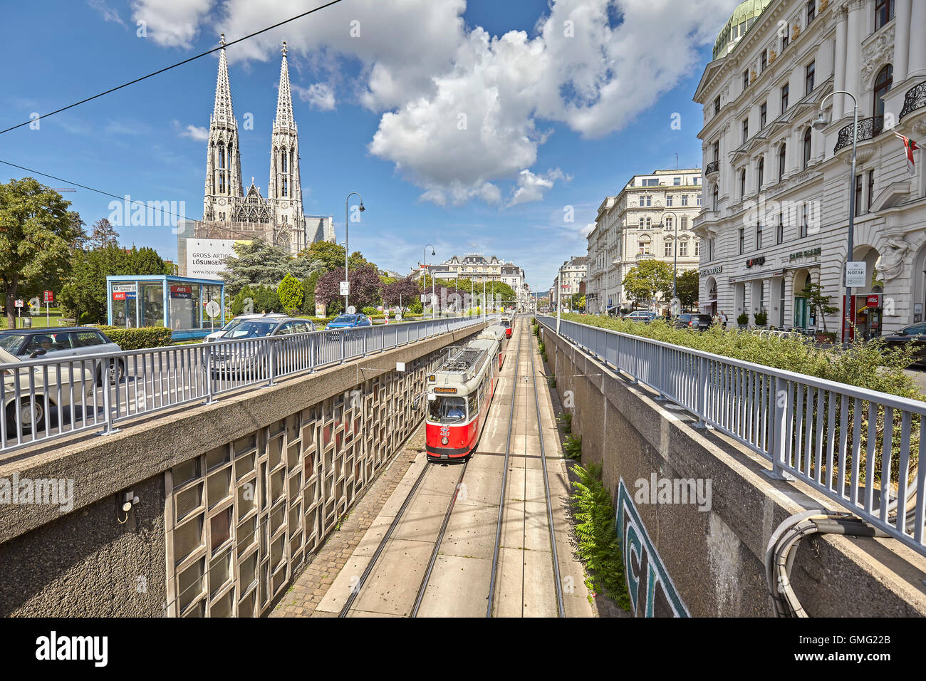 Vienna, Austria - August 14, 2016: Tram entering tunnel with Votive Church in distance. Stock Photo