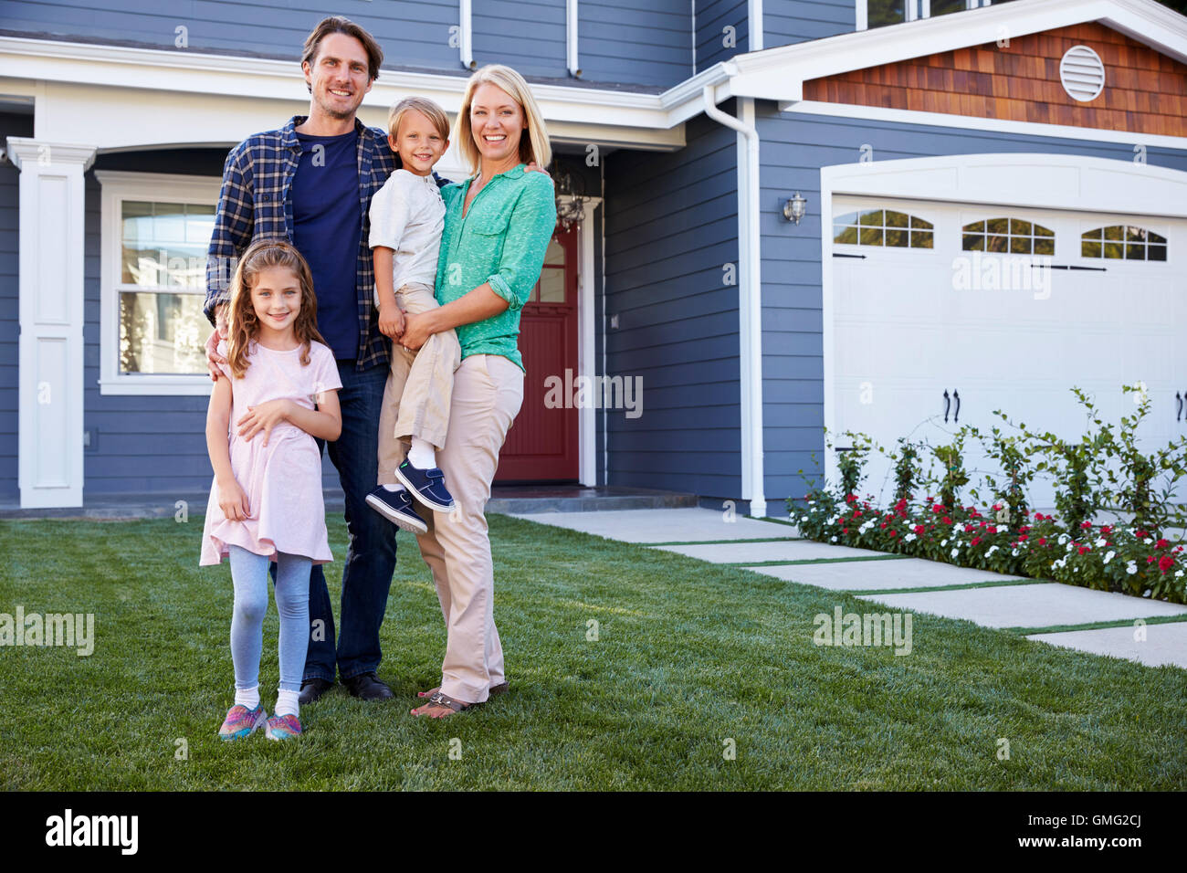 Portrait Of Family Standing Outside House Stock Photo - Alamy