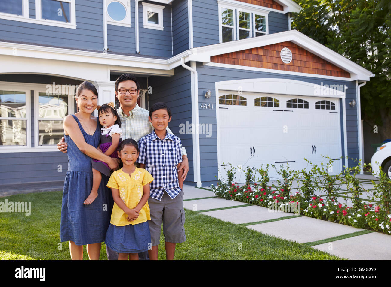 Portrait Of Family Standing Outside House Stock Photo Alamy