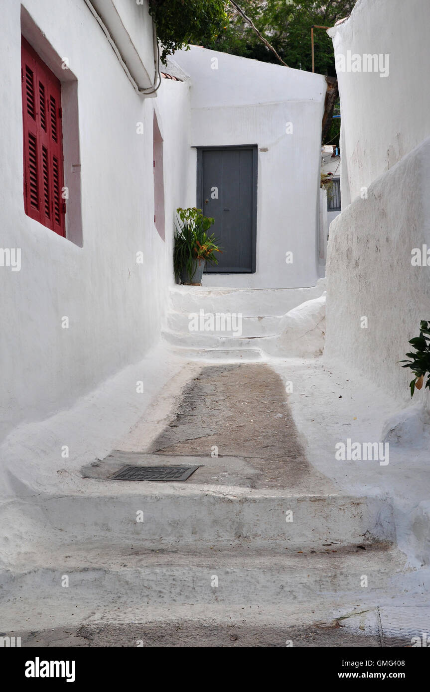 Houses and narrow street with steps painted white in the traditional Anafiotika neighborhood of Plaka, Athens Greece. Stock Photo