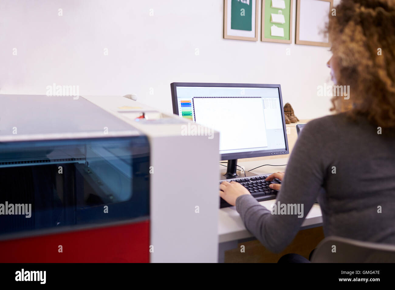 Female Designer Operating CAD System For Laser Cutter Stock Photo - Alamy