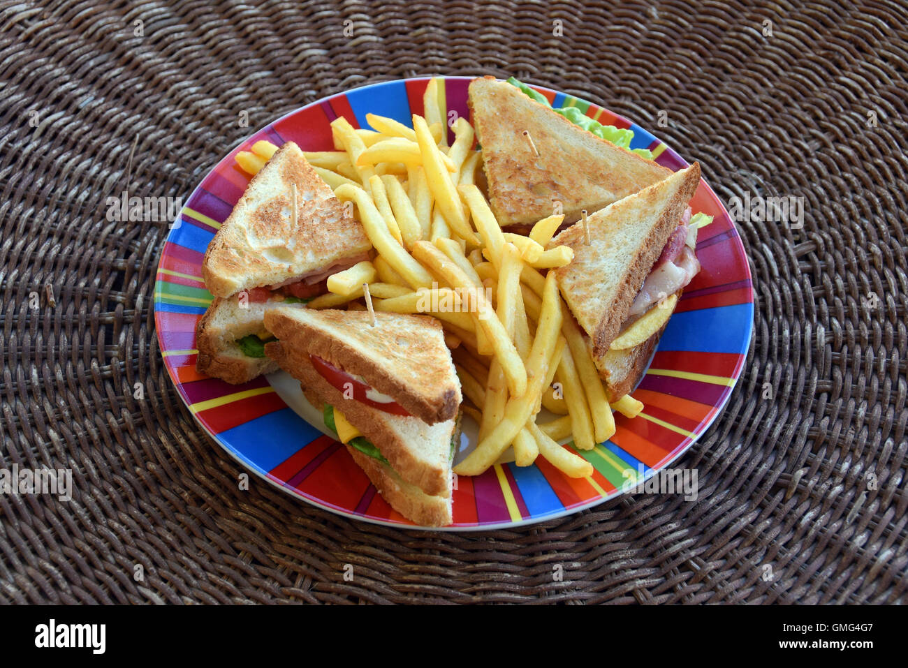 Club sandwich with french fries. Fast food dinner. Stock Photo