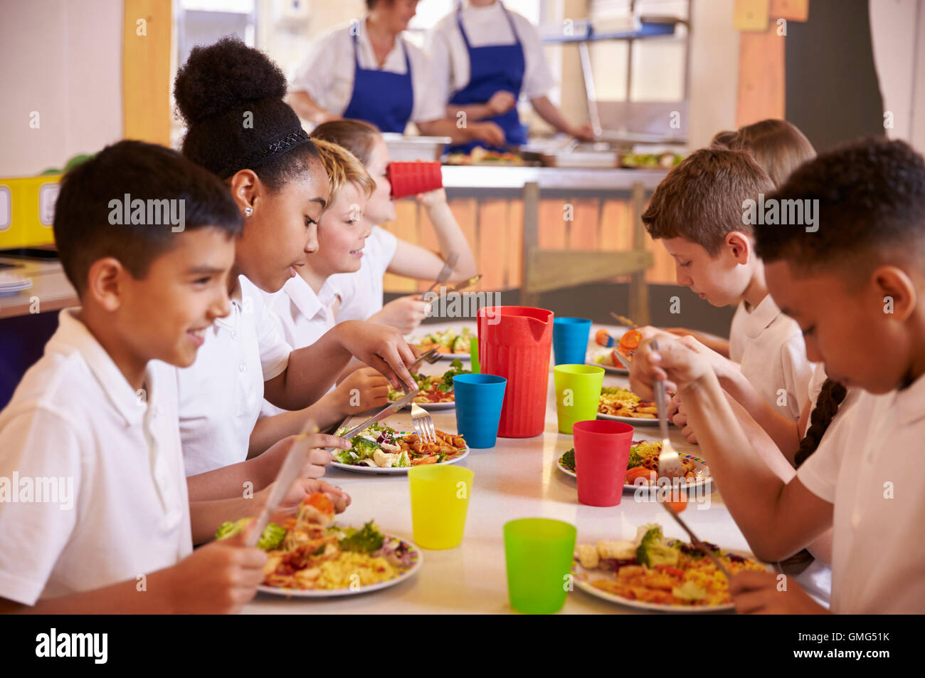 https://c8.alamy.com/comp/GMG51K/primary-school-kids-eating-at-a-table-in-school-cafeteria-GMG51K.jpg