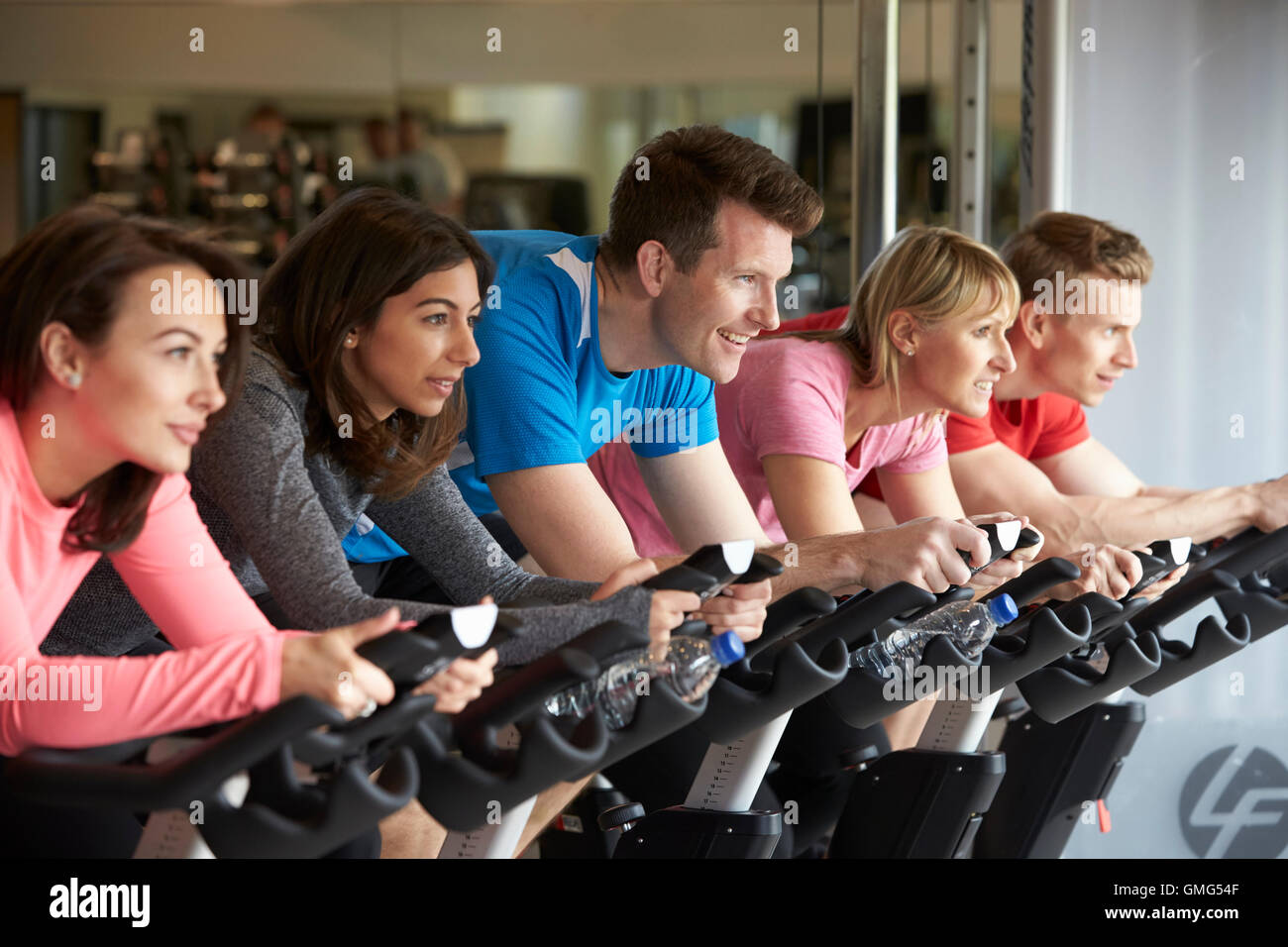Side view of a spinning class on exercise bikes at a gym Stock Photo ...