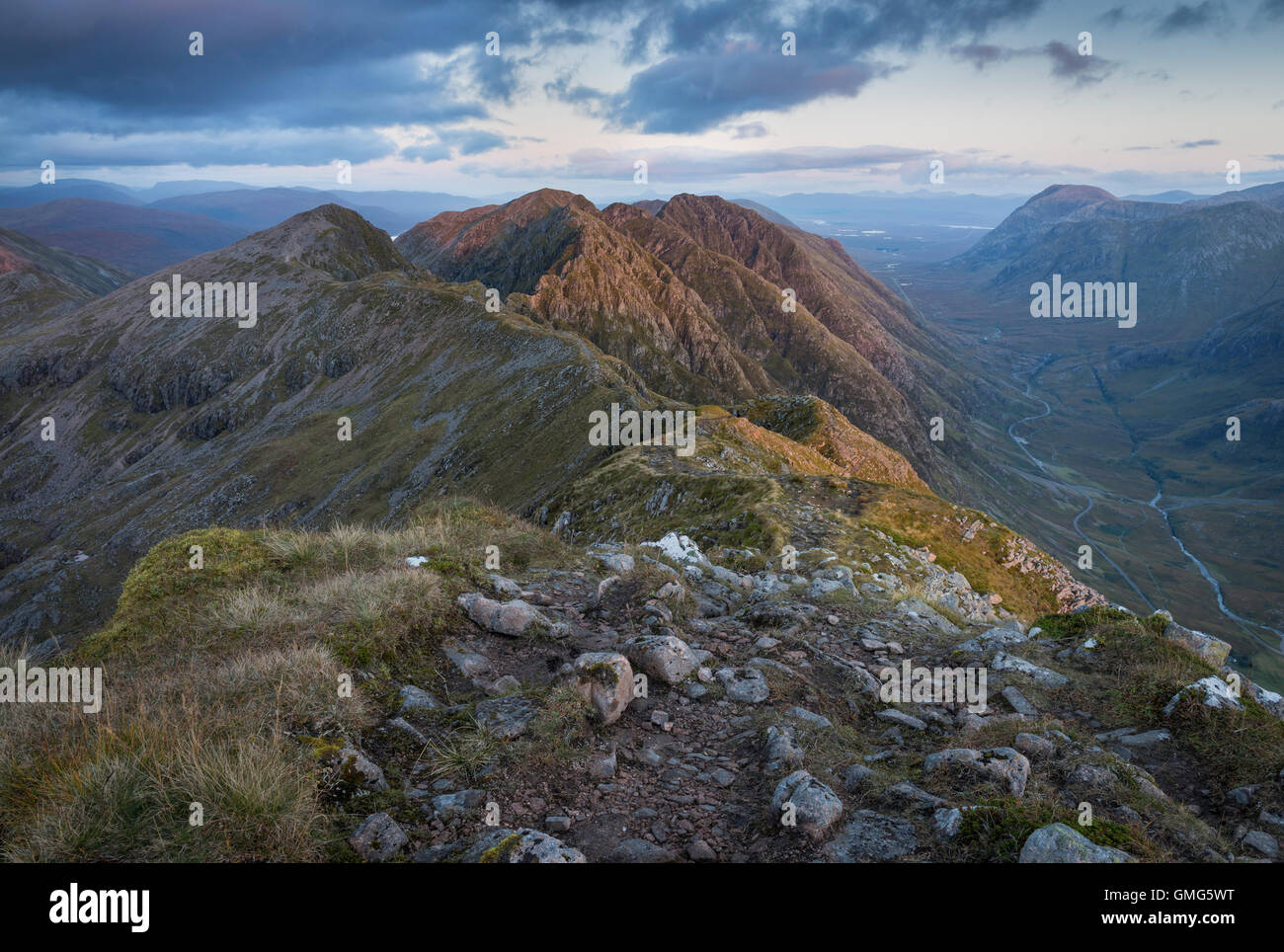 Last evening sunlight on the Aonach Eagach ridge high above Glen Coe, Scottish Highlands, Scotland Stock Photo