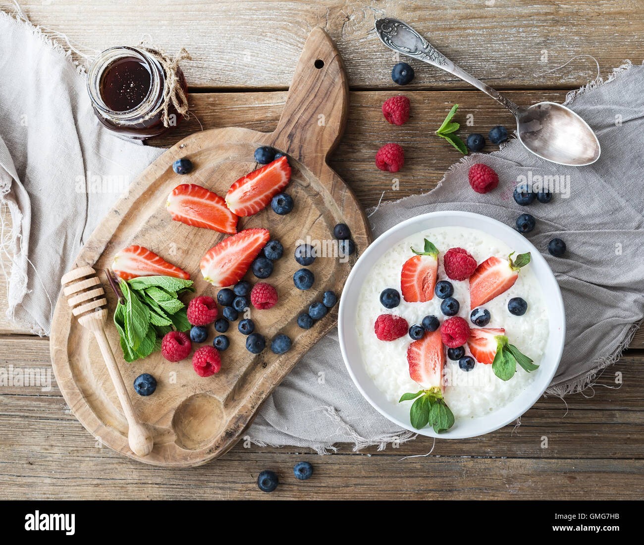 Healthy breakfast set. Rice cereal or porridge with berries and honey Stock Photo