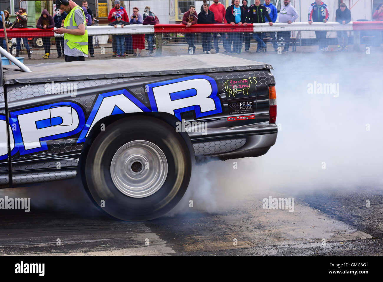 drag racing car wheel spinning to generate heat in tyres to increase