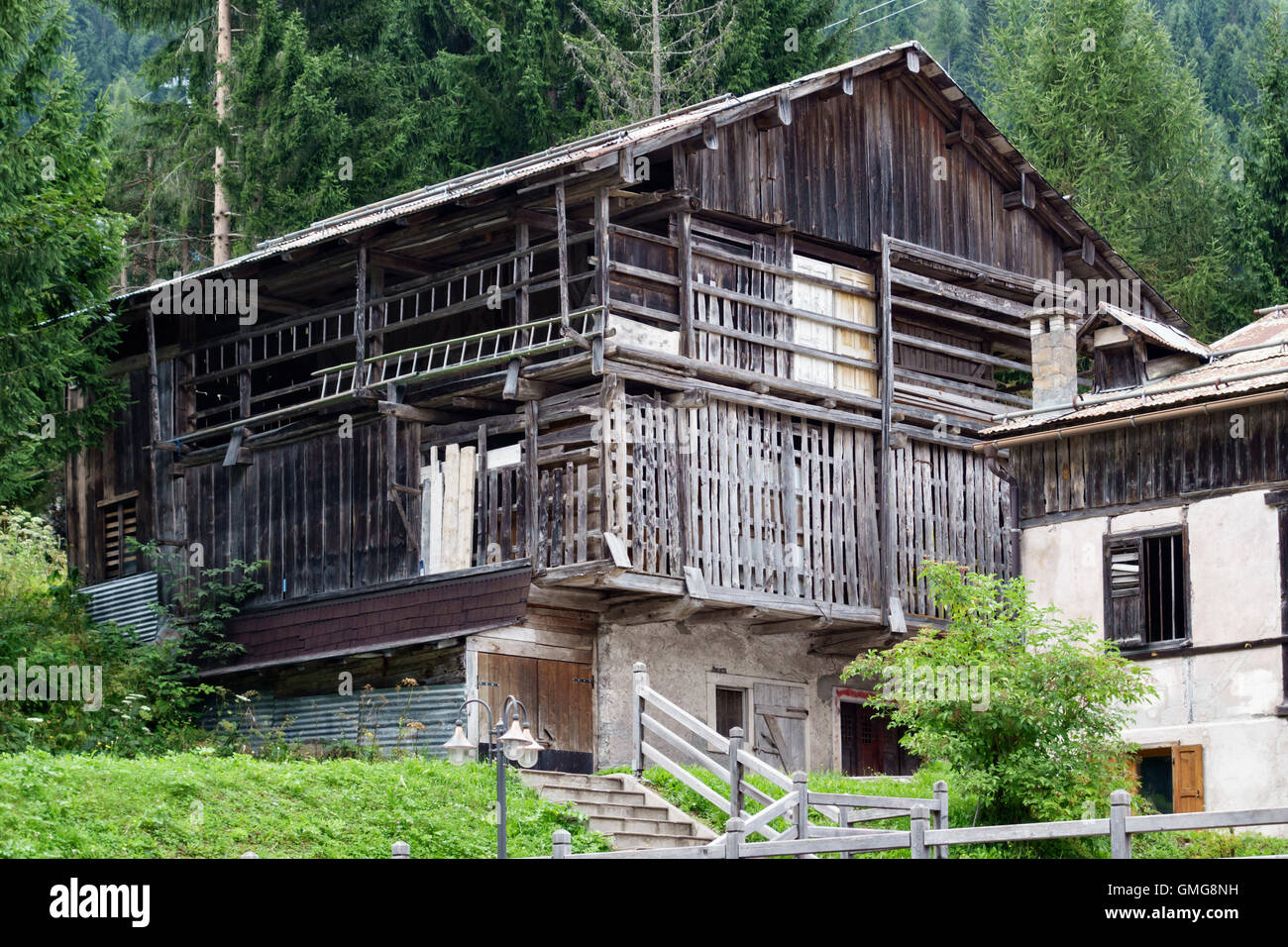 The Dolomites, Trentino, northern Italy. A traditional old wooden barn in the mountain village of Falcade Stock Photo