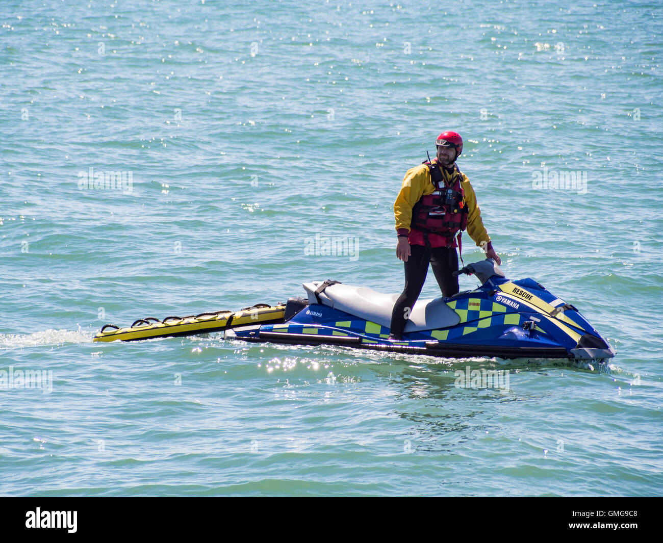 A RNLI Lifeguard on a jetski patrols the beach at Southsea, Portsmouth