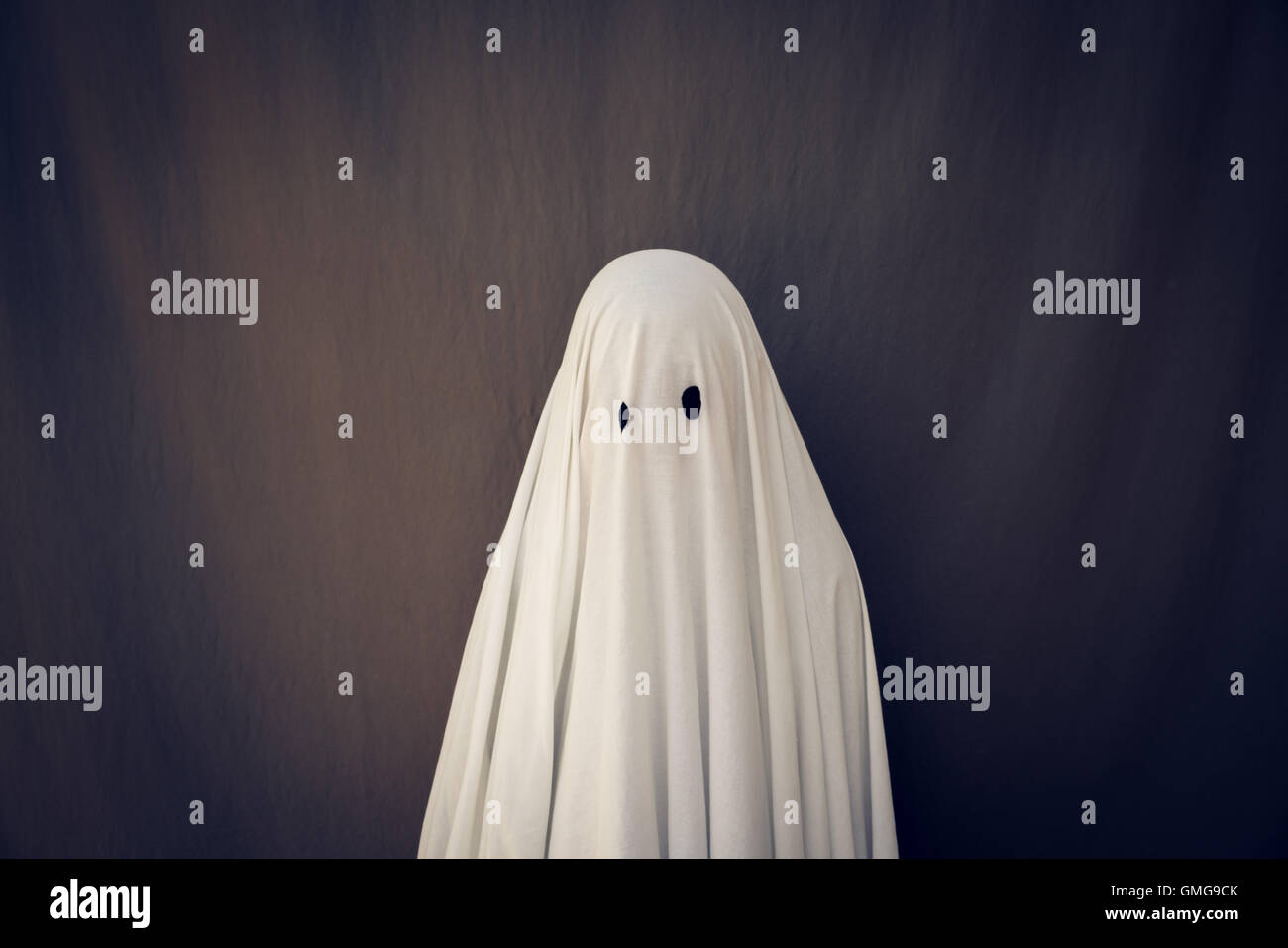 White Ghost on a gray background. Halloween symbol. Stock Photo