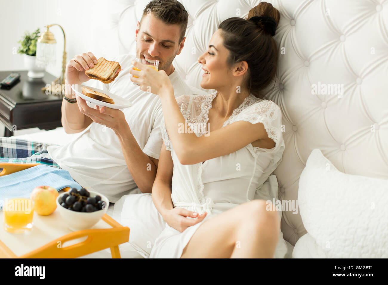 Young loving couple having breakfast in bed Stock Photo Alamy