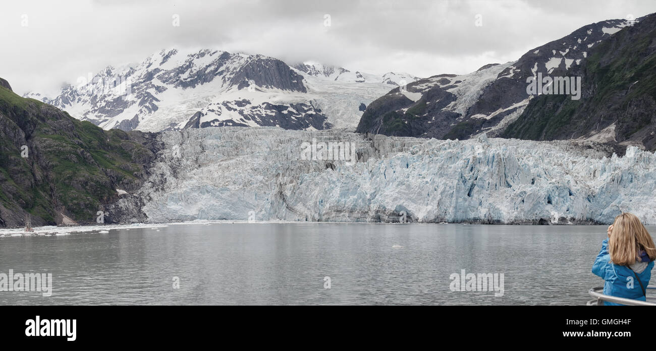 A women takes a picture of Surprise Glacier on Prince William Sound, Alaska. Stock Photo