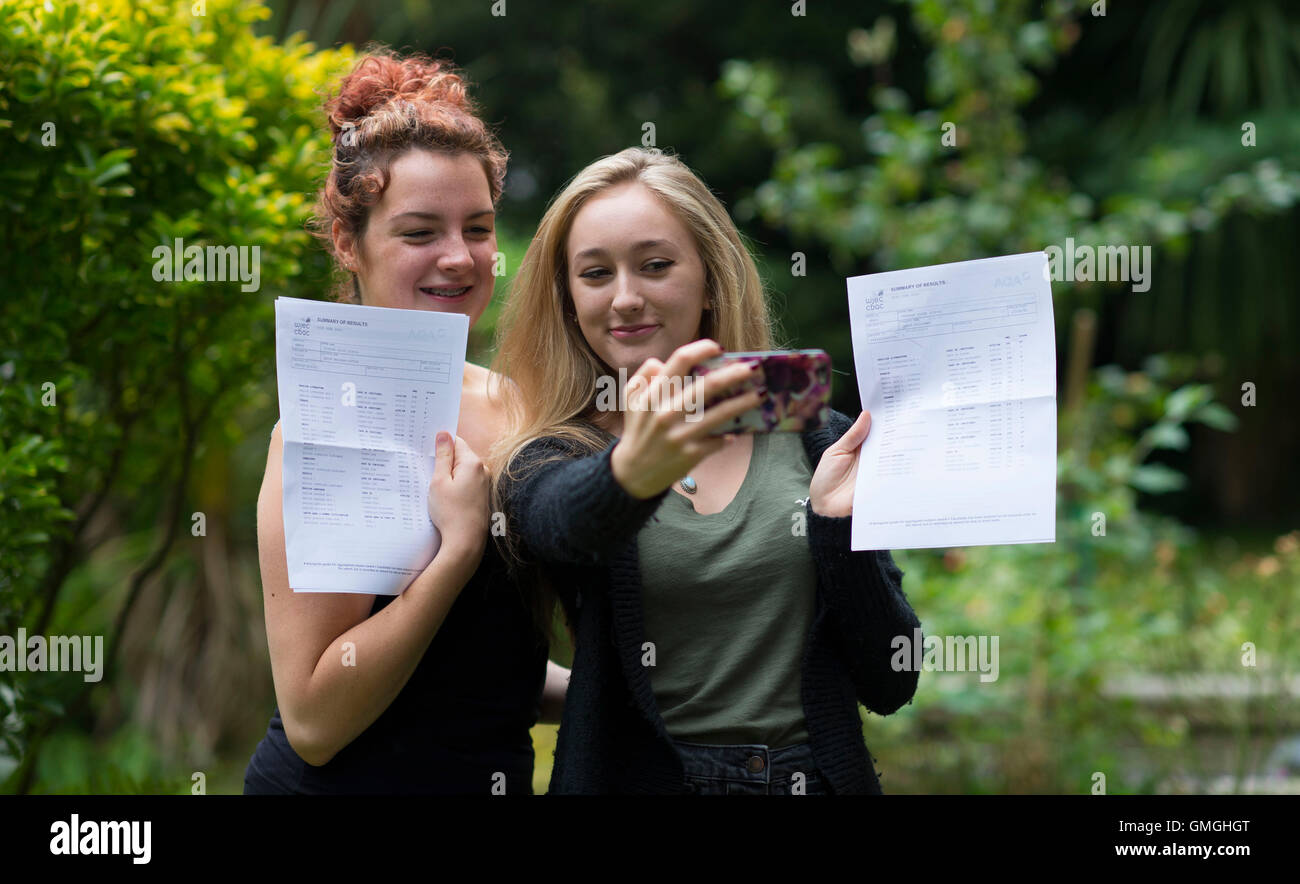 Two Female Girls Celebrate Their GCSE Exam Results At A School In two-female-girls-celebrate-their-gcse-exam-results-at-a-school-in