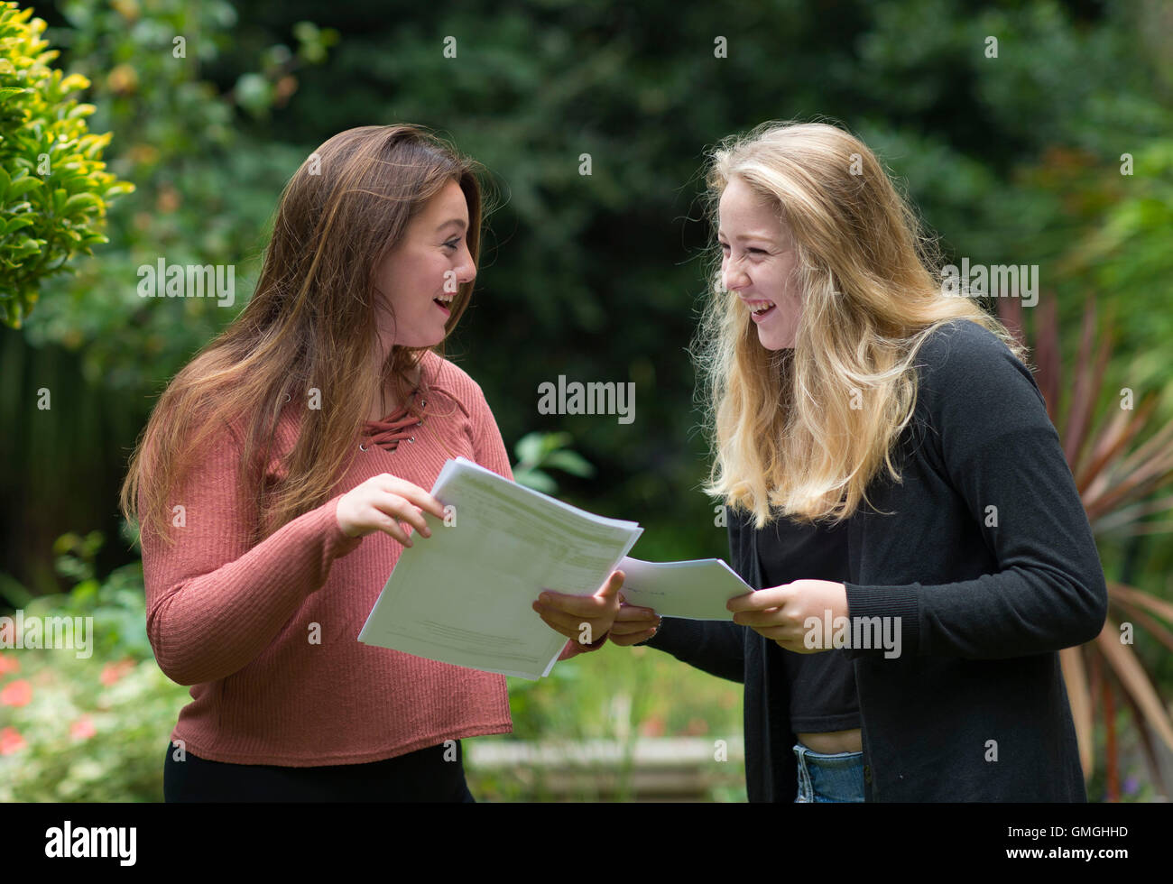 Two female girls celebrate their GCSE exam results at a school in Swansea, South Wales. Stock Photo