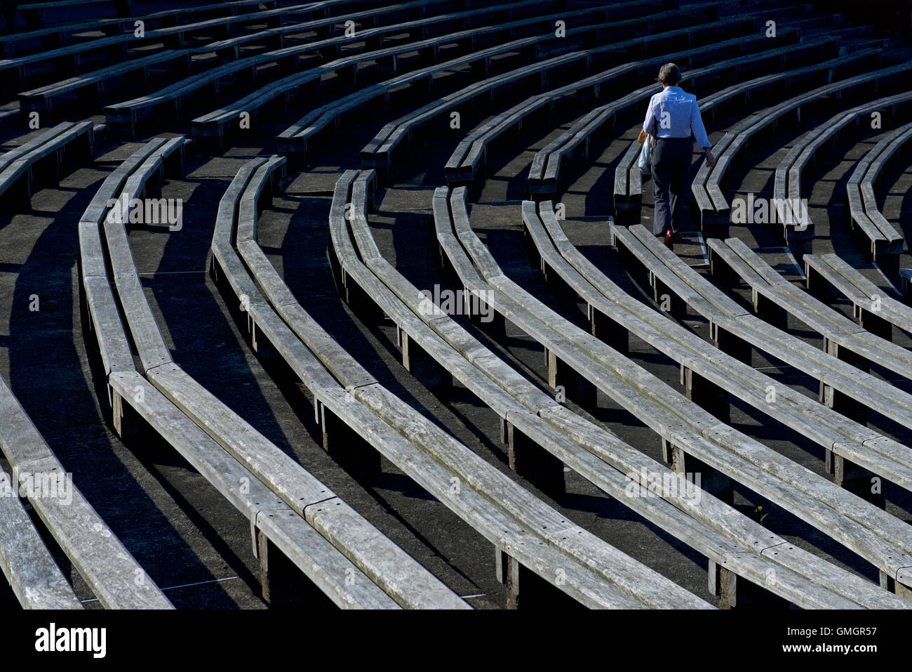 Spectator amongst the wooden seating at Scarborough Cricket Club, North Marine Road, Scarborough, North Yorkshire UK Stock Photo