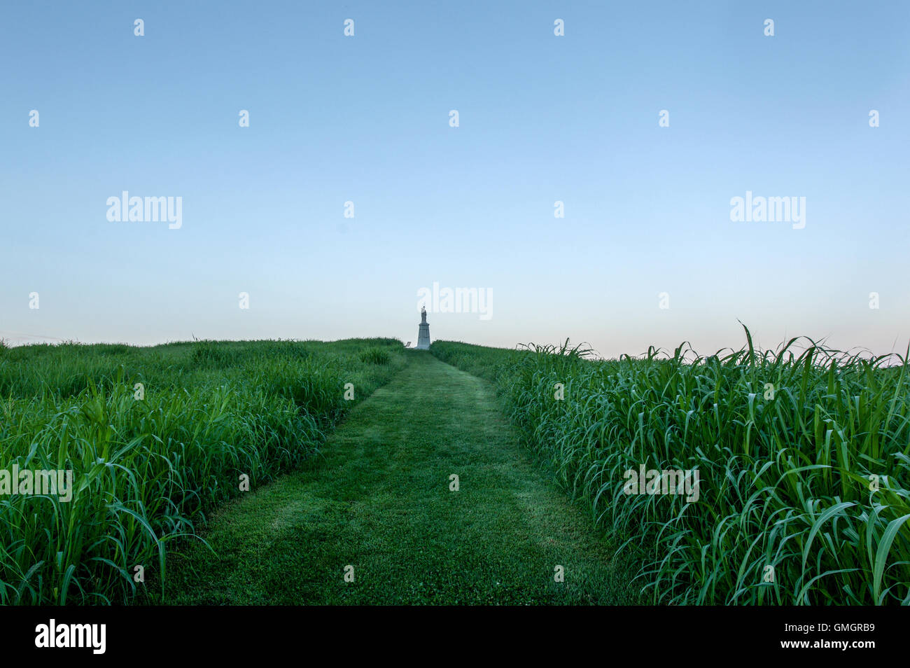 A religious statue stands at the end of a pathway on a hilltop at the Abbey of Gethsemani, a Trappist monastery in Kentucky Stock Photo