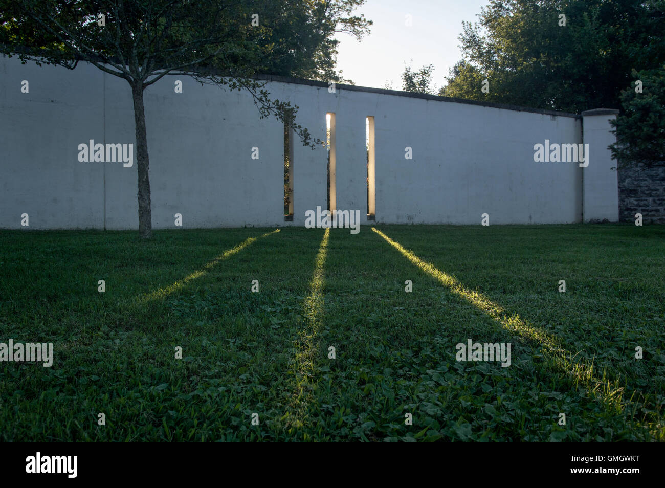 Light breaks through openings in a wall at the monks' garden at the Abbey of Gethsemani, a Trappist monastery in Kentucky Stock Photo