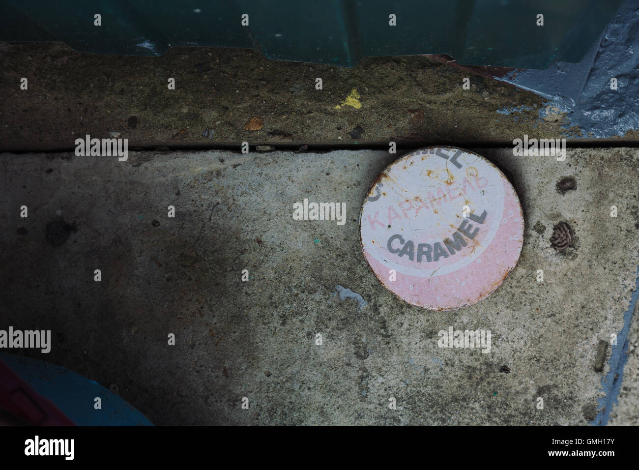 Flat round object with caramel word on cement ground Stock Photo - Alamy