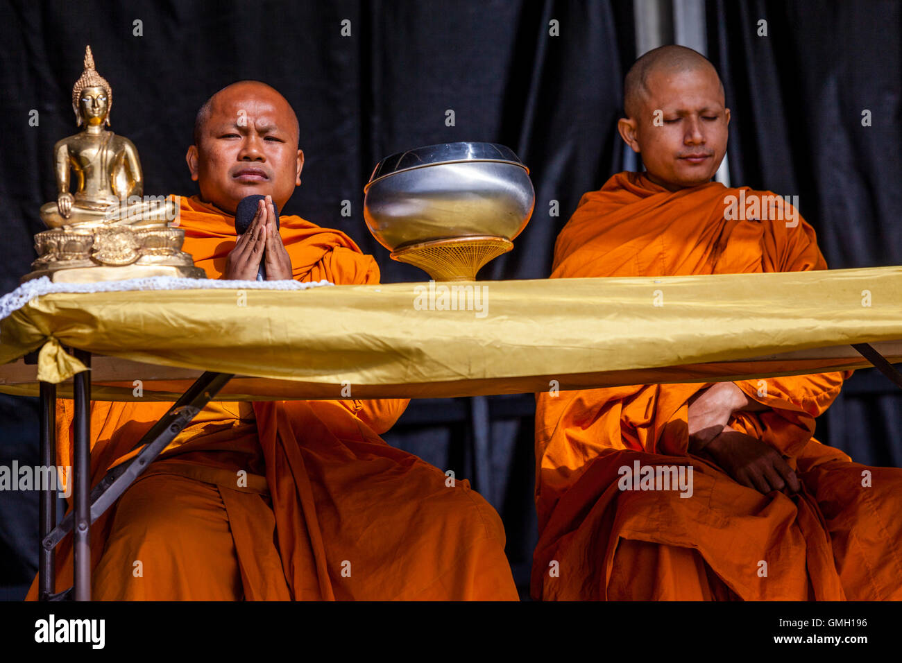 Two Buddhist Monks Chanting At The Brighton Thai Festival, Preston Park, Brighton, Sussex, UK Stock Photo