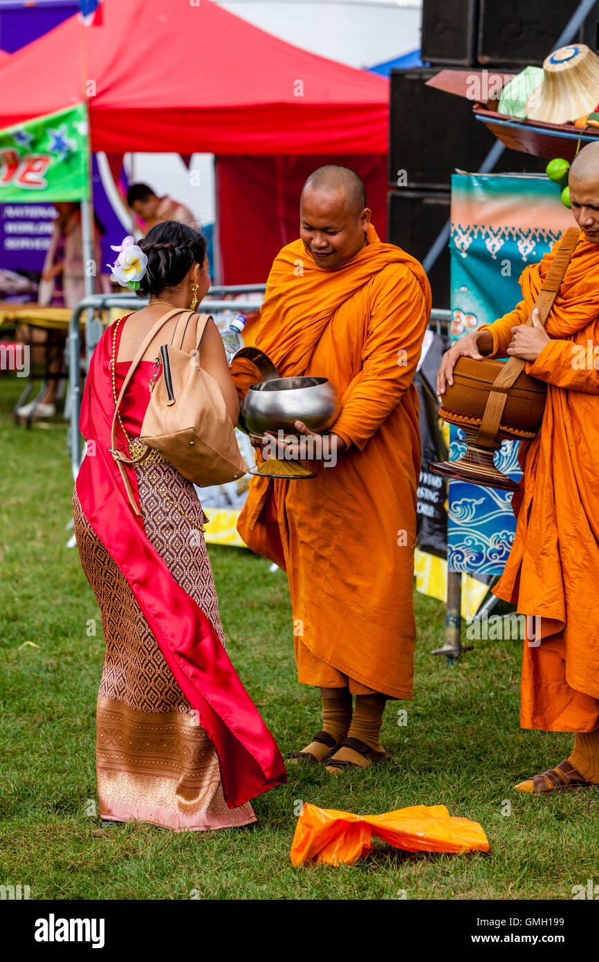 Thai People Offer Food To Two Monks At The Brighton Thai Festival