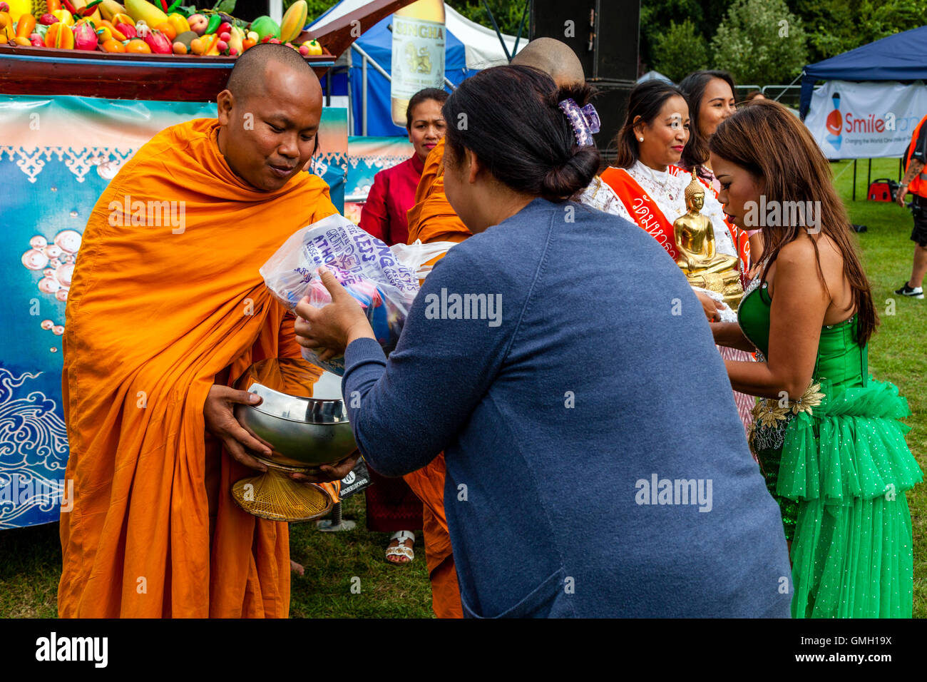 Thai People Offer Food To Two Monks At The Brighton Thai Festival
