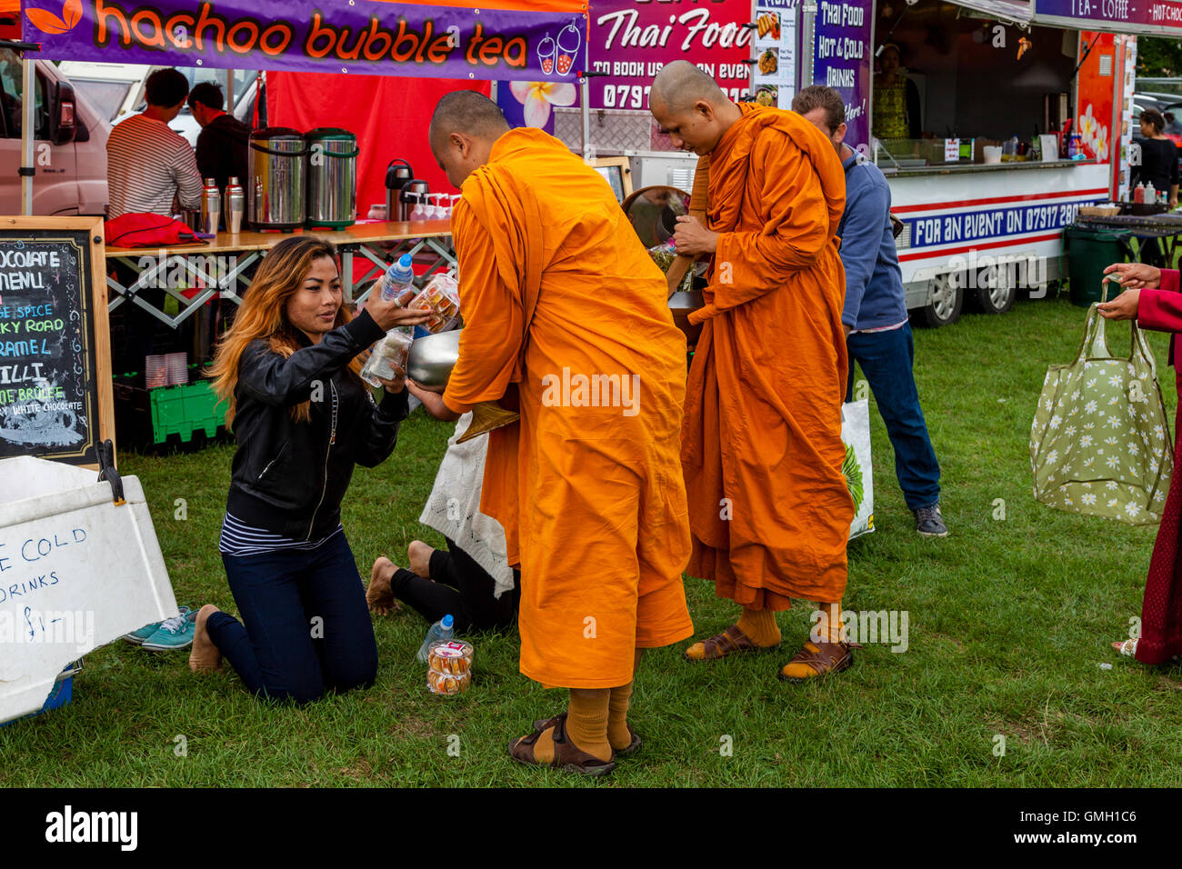 Thai People Offer Food To Two Monks At The Brighton Thai Festival
