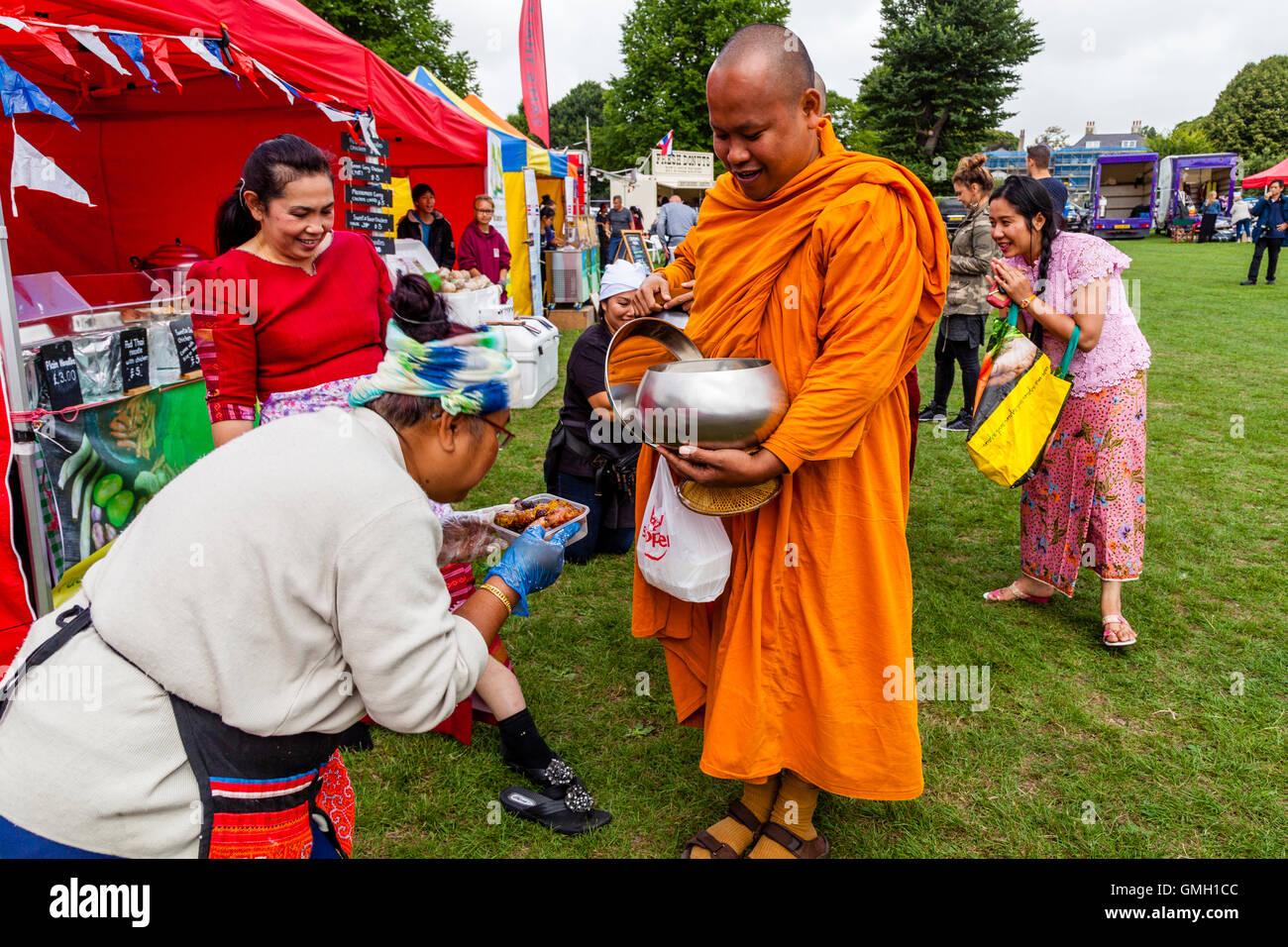 Thai People Offer Food To Two Monks At The Brighton Thai Festival
