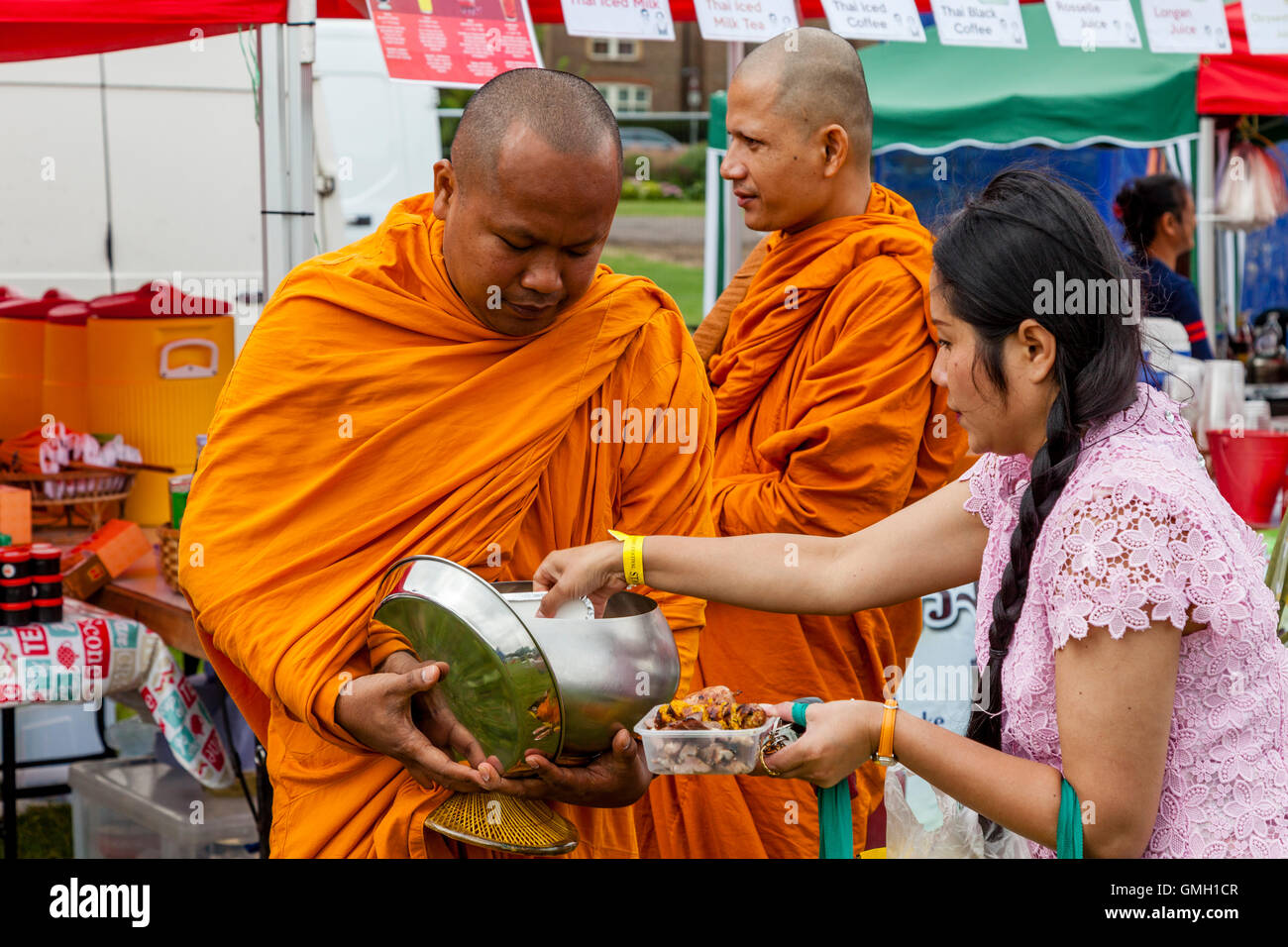 Thai People Offer Food To Two Monks At The Brighton Thai Festival