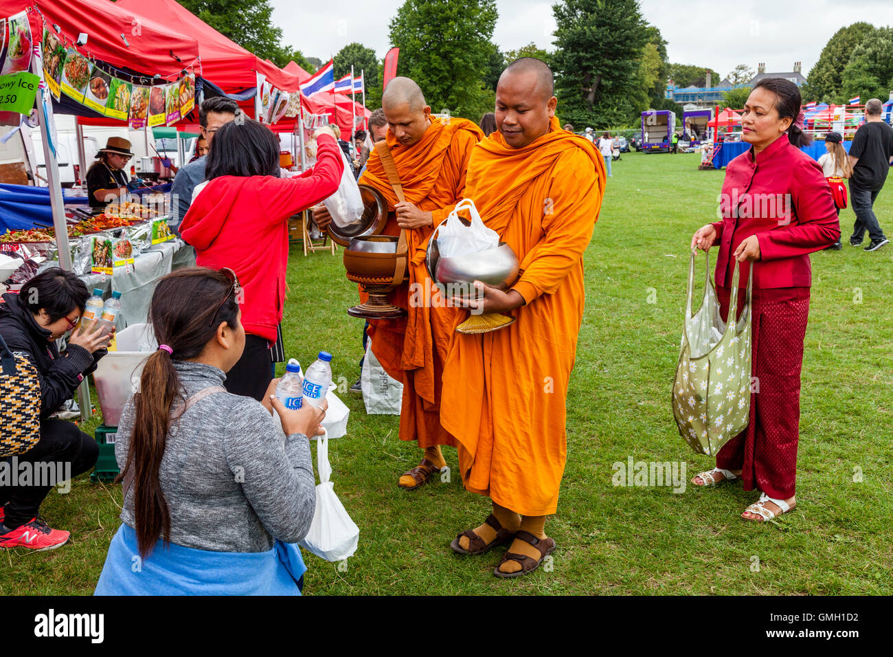 Thai People Offer Food To Two Monks At The Brighton Thai Festival