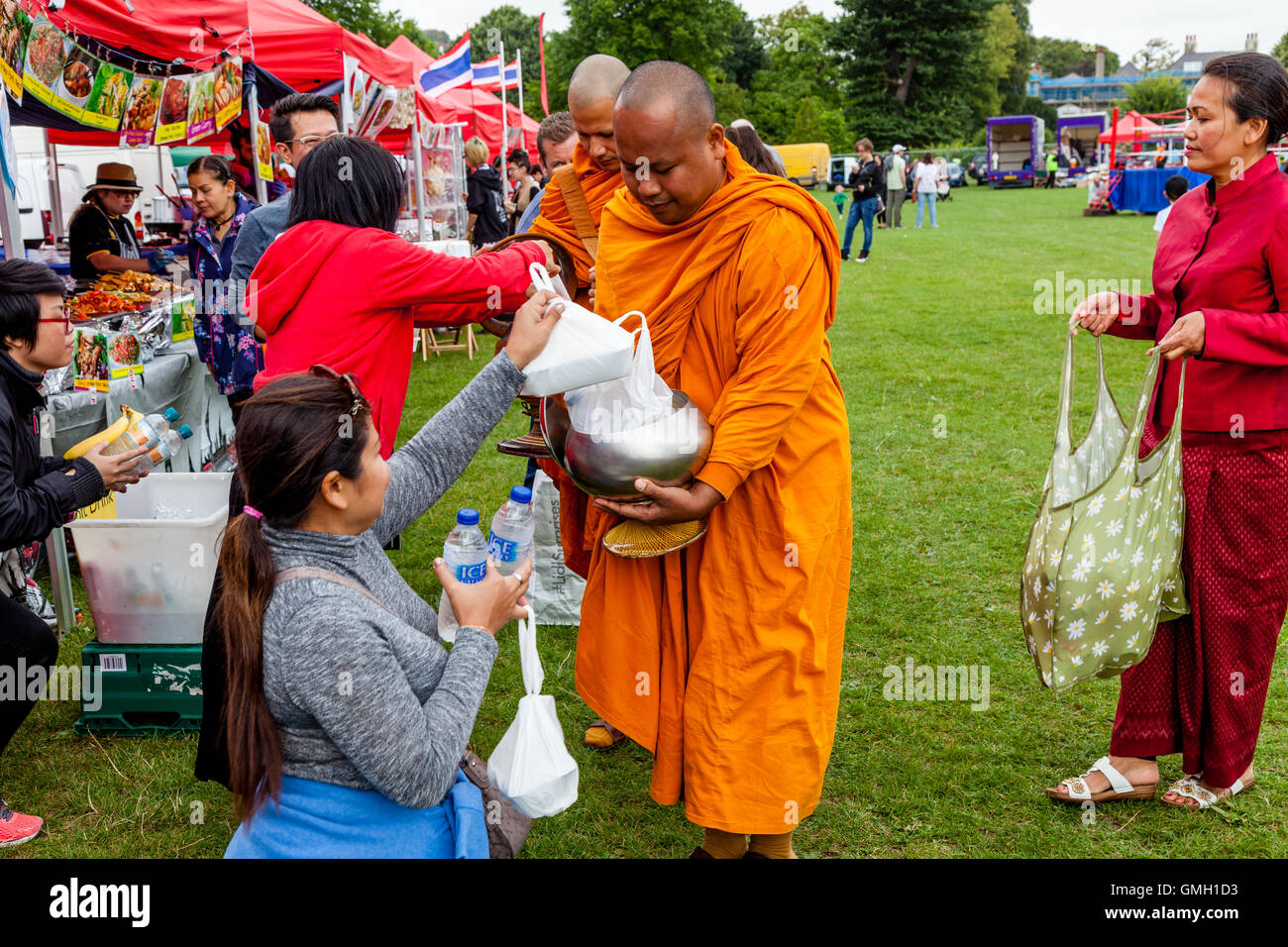 Thai People Offer Food To Two Monks At The Brighton Thai Festival