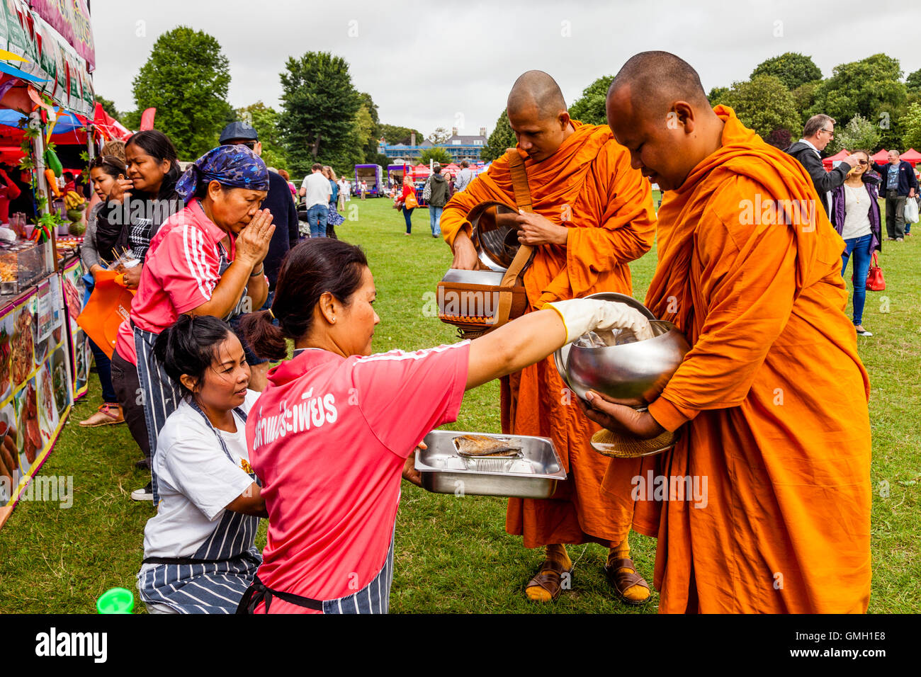 Thai People Offer Food To Two Monks At The Brighton Thai Festival
