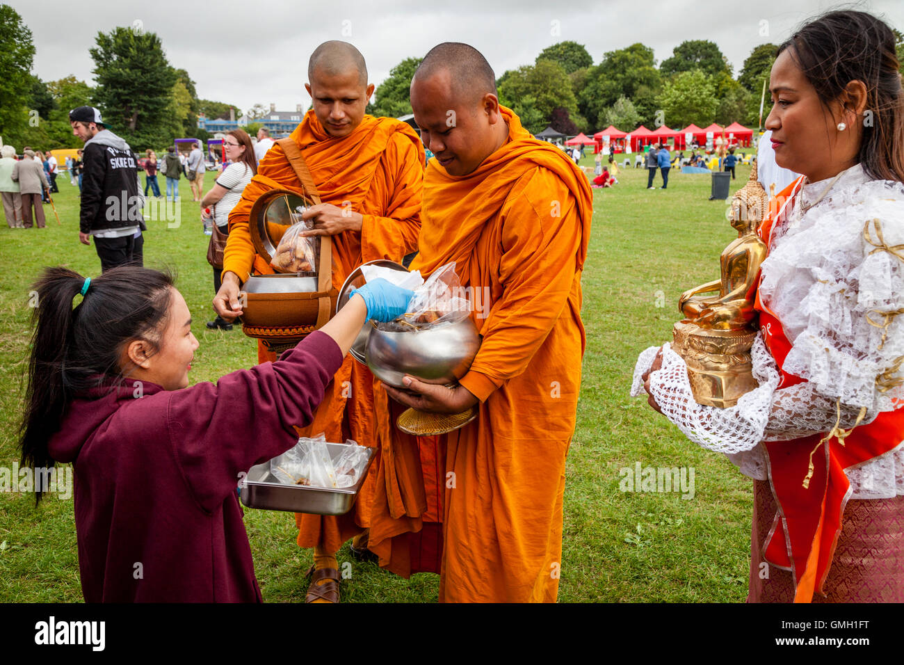 Thai People Offer Food To Two Monks At The Brighton Thai Festival
