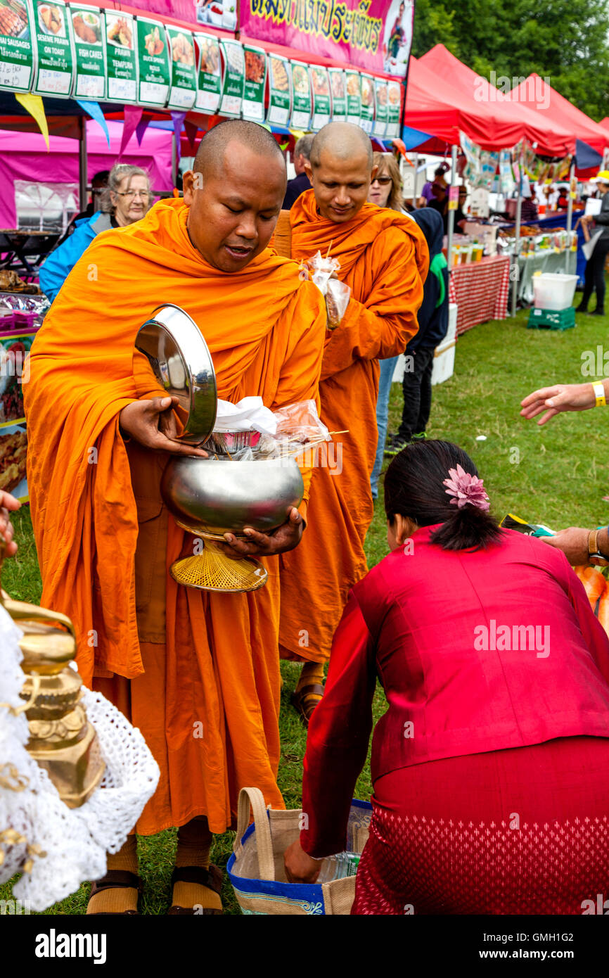 Thai People Offer Food To Two Monks At The Brighton Thai Festival