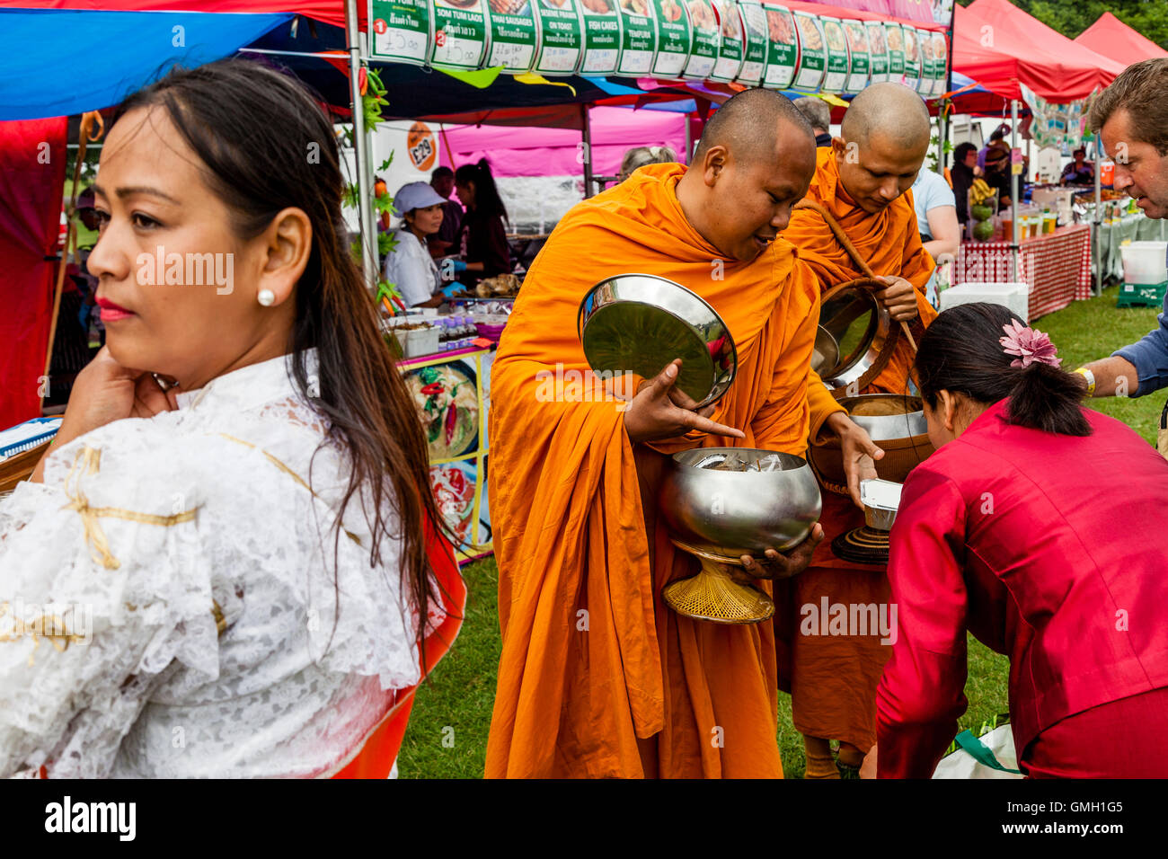 Thai People Offer Food To Two Monks At The Brighton Thai Festival