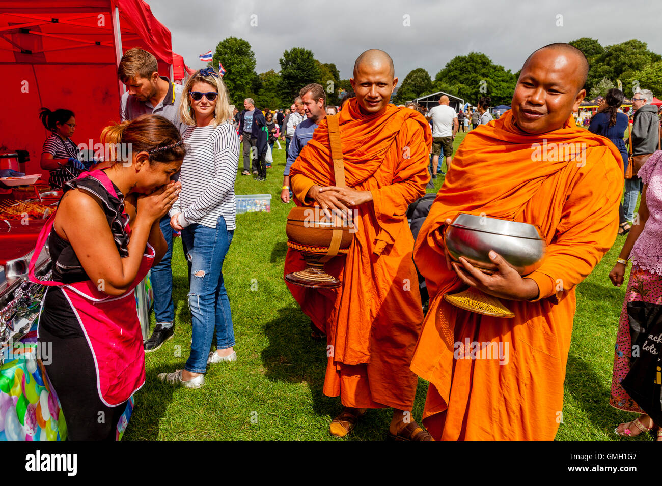 Thai People Offer Food To Two Monks At The Brighton Thai Festival