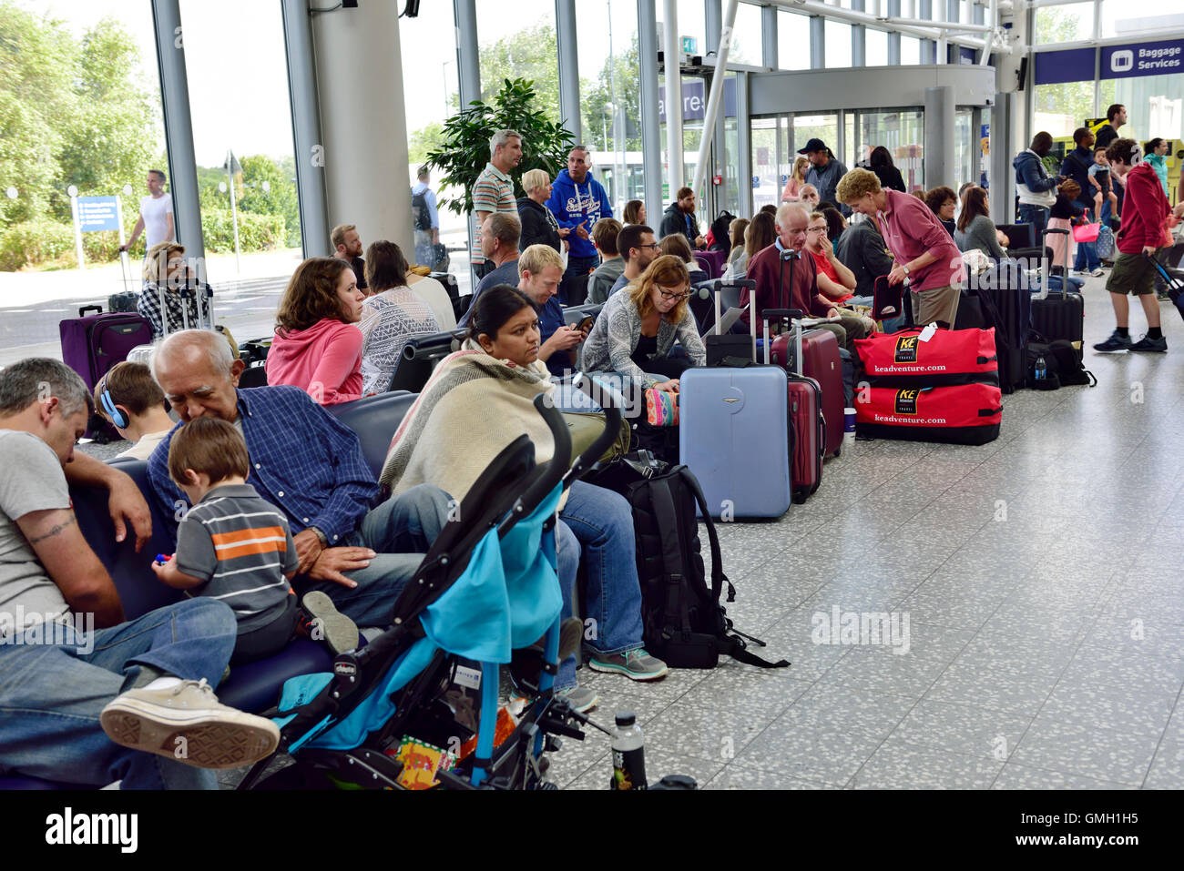 People waiting for bag checkin at airport Stock Photo Alamy