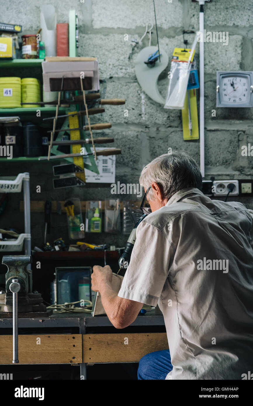 Senior mechanic working in garage Stock Photo