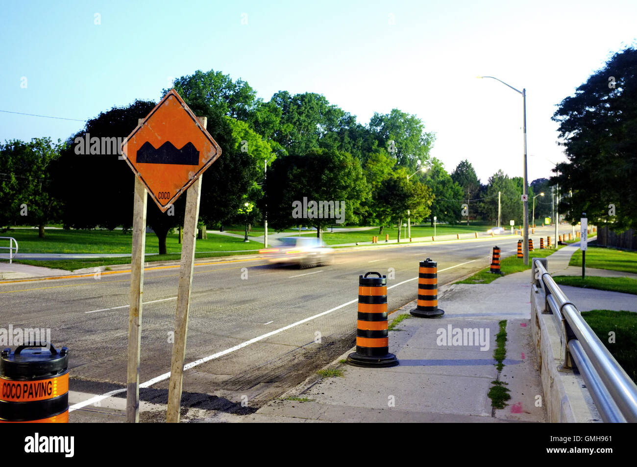 A car passes a set of traffic cones and speed bump sign in the Canadian city of London, Ontario