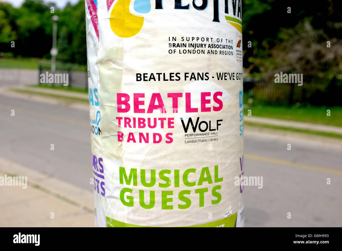 Adverts on a lamppost in a Canadian city for a Beatles tribute festival. Stock Photo
