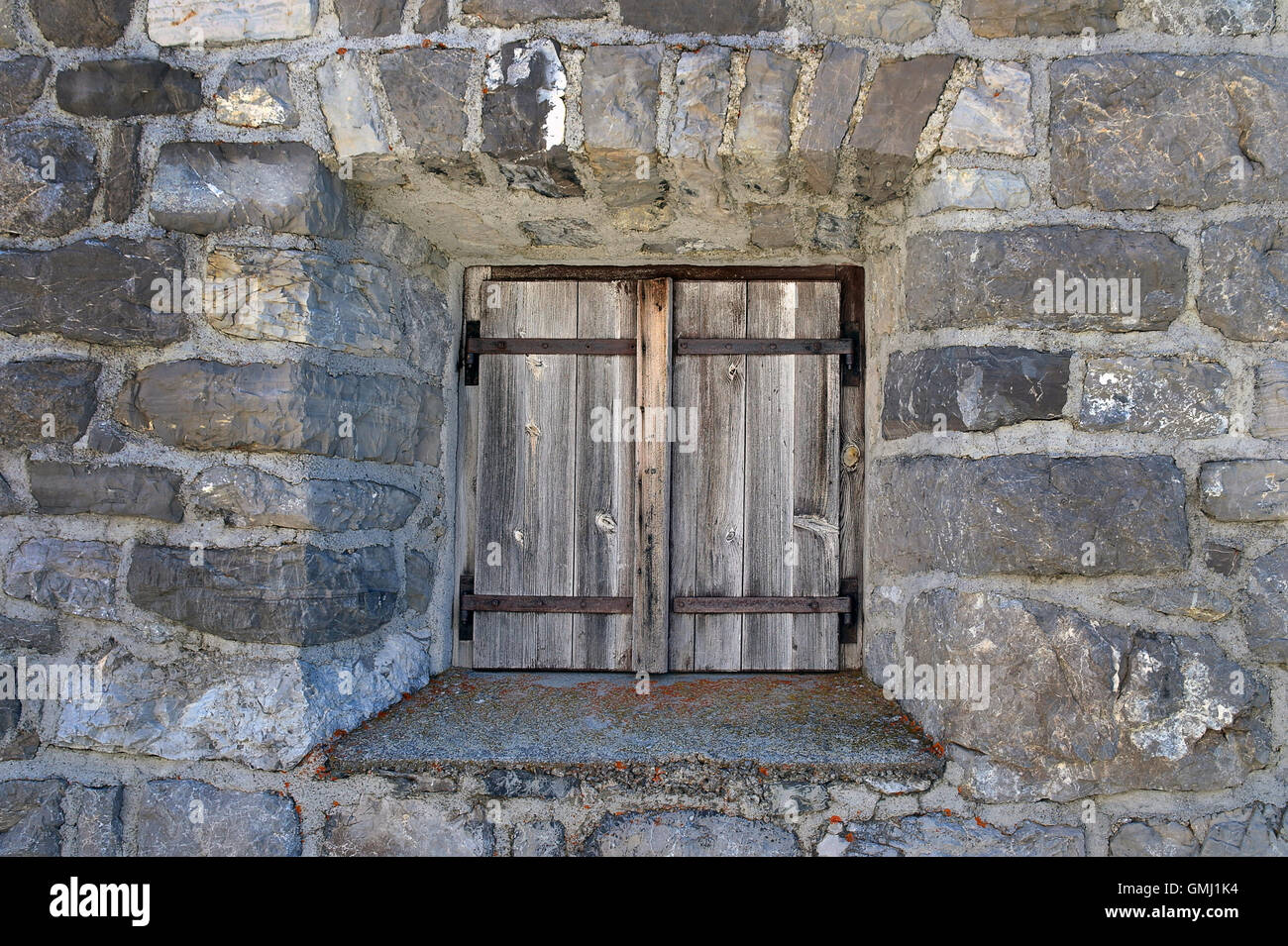 Old weathered door in stone wall Stock Photo - Alamy