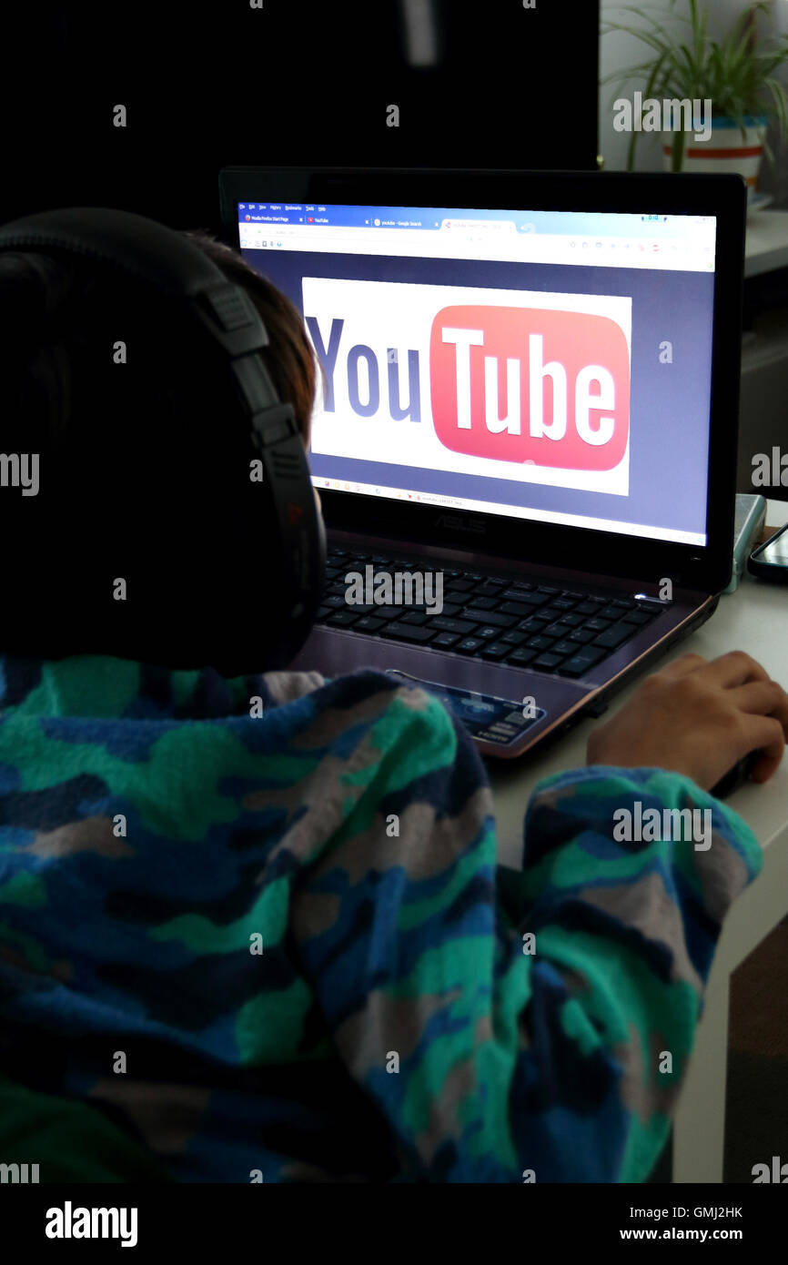 Child watching YouTube on a laptop Stock Photo