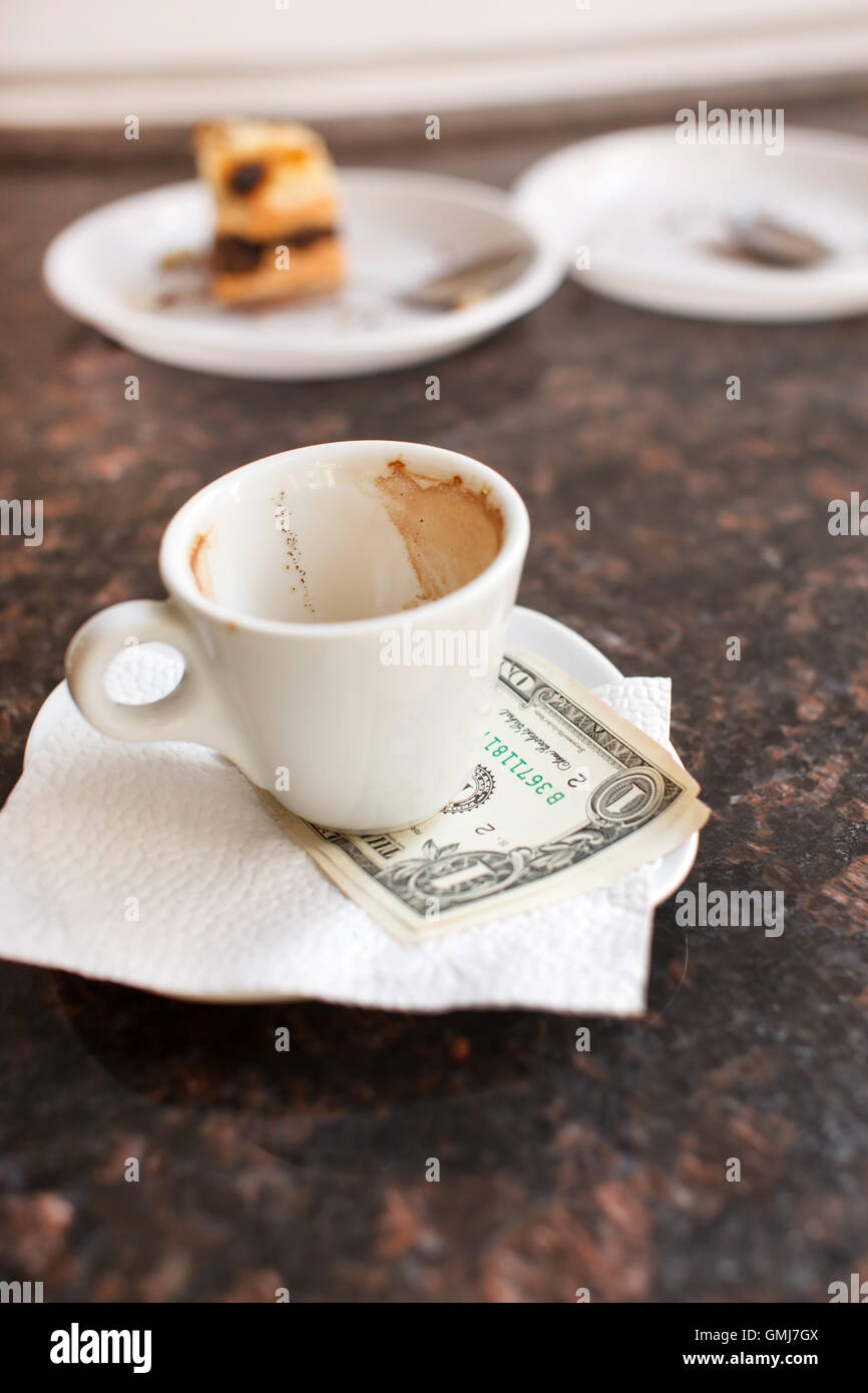 dollar bills under a coffee cup Stock Photo Alamy